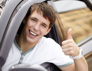 Smiling driver holding tumbs up