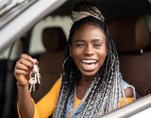 Smiling driver holding car keyes